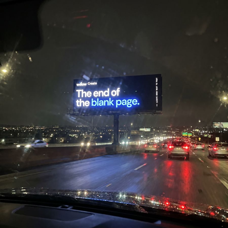 Willow Create highway billboard at night reading 'The end of the blank page.'